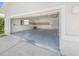 Attached garage with open door, concrete floor, and shelving at 51 Sun Dunes Cir, Ponce Inlet, FL 32127