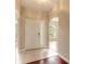 Bright entryway with hardwood floors, a white door and view into the living room at 117 Opal Hill Cir, Daytona Beach, FL 32124