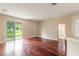 Living room with hardwood floors and sliding glass doors to patio at 117 Opal Hill Cir, Daytona Beach, FL 32124