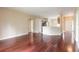 Open living room with hardwood floors and access to kitchen and entryway at 117 Opal Hill Cir, Daytona Beach, FL 32124