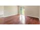 Bright bedroom with hardwood floors and sliding glass doors leading to backyard at 117 Opal Hill Cir, Daytona Beach, FL 32124