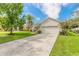 Single story house with attached garage and a lush green lawn at 117 Opal Hill Cir, Daytona Beach, FL 32124