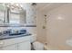 Bathroom with blue vanity, shower, and nautical wallpaper at 1111 Hill St # U3, New Smyrna Beach, FL 32169