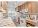 Kitchen with light wood cabinets and white appliances at 1111 Hill St # U3, New Smyrna Beach, FL 32169