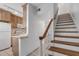 Wooden staircase with kitchen view from landing at 1111 Hill St # U3, New Smyrna Beach, FL 32169