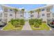 Front view of two-story building with landscaping at 1111 Hill St # U3, New Smyrna Beach, FL 32169