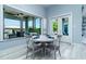 Bright dining area with round table and four chairs, near sliding glass doors at 113 Via Benevento, New Smyrna Beach, FL 32169