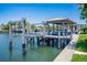 Private dock with boat lift and covered seating area at 113 Via Benevento, New Smyrna Beach, FL 32169