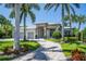 Luxury home with circular driveway and lush landscaping at 113 Via Benevento, New Smyrna Beach, FL 32169