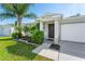 House exterior featuring a dark brown front door and neatly landscaped yard at 5321 Cordgrass Bend Ln, Port Orange, FL 32128