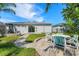 Backyard with patio, pond view, and lush landscaping at 5321 Cordgrass Bend Ln, Port Orange, FL 32128