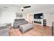 Living room with hardwood floors, fireplace, and large TV at 5321 Cordgrass Bend Ln, Port Orange, FL 32128