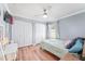 Bright bedroom with a queen bed, large closet, and wood flooring at 5321 Cordgrass Bend Ln, Port Orange, FL 32128