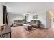 Spacious living room featuring gray reclining sofas and wood-look floors at 5321 Cordgrass Bend Ln, Port Orange, FL 32128
