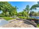 Large backyard with patio, pond view, and trampoline at 5321 Cordgrass Bend Ln, Port Orange, FL 32128
