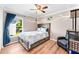 Cozy bedroom featuring a queen-size bed, tree mural, and ample closet space at 5321 Cordgrass Bend Ln, Port Orange, FL 32128