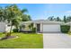 Single-story home with two car garage and well-maintained lawn at 5321 Cordgrass Bend Ln, Port Orange, FL 32128