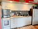 Modern kitchen with white cabinets and appliances at 3700 S Atlantic Ave # 402, New Smyrna Beach, FL 32169