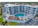 Aerial view of condo building with pool and ocean view at 3700 S Atlantic Ave # 402, New Smyrna Beach, FL 32169