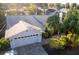 Single-story home with gray roof, white exterior and a paver driveway at 1312 2Nd St, Edgewater, FL 32132