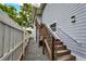 Back exterior with wooden stairs and gravel at 407 Douglas St, New Smyrna Beach, FL 32168
