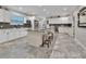 Modern kitchen with white cabinets, a large island, and gray flooring at 407 Douglas St, New Smyrna Beach, FL 32168