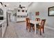 Open kitchen with white cabinets and breakfast nook at 407 Douglas St, New Smyrna Beach, FL 32168