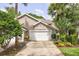 Two-story townhouse with a double-car garage and landscaped yard at 2051 Cornell Pl, Port Orange, FL 32128