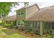Tan house with a sunroom and mature landscaping at 2051 Cornell Pl, Port Orange, FL 32128