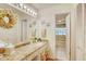 Spa-like bathroom with granite countertop, a large mirror, and a bathtub at 2051 Cornell Pl, Port Orange, FL 32128