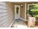 Inviting front entrance with a white door, wreath, and landscaping at 2051 Cornell Pl, Port Orange, FL 32128
