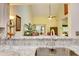 Modern kitchen with granite countertops and white cabinets at 2051 Cornell Pl, Port Orange, FL 32128