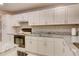Updated kitchen featuring white cabinets and granite counters at 2051 Cornell Pl, Port Orange, FL 32128