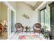Peaceful sunroom with wicker chairs and a colorful rug at 2051 Cornell Pl, Port Orange, FL 32128