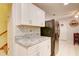 Bright kitchen with white cabinets, granite countertops, and black appliances at 2051 Cornell Pl, Port Orange, FL 32128