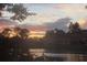 Sunset over calm water with a house in the background at 2051 Cornell Pl, Port Orange, FL 32128