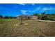 View of the house from the side yard, showing a spacious lawn and landscaping at 15190 Cr-565A, Clermont, FL 34711