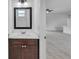 Simple bathroom with vanity, mirror and view to living room at 15190 Cr-565A, Clermont, FL 34711