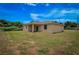 Rear view of a house highlighting a covered patio area and a large backyard at 15190 Cr-565A, Clermont, FL 34711