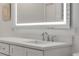 Bathroom with a lit vanity mirror and quartz countertop at 40 Oak Tree Dr, New Smyrna Beach, FL 32169