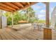 Spacious deck with seating area, kayak storage, and partial view of the canal at 40 Oak Tree Dr, New Smyrna Beach, FL 32169