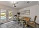Casual dining area with wooden table and chairs, near sliding doors to the pool at 40 Oak Tree Dr, New Smyrna Beach, FL 32169