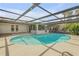Inviting kidney-shaped pool with a screened enclosure at 40 Oak Tree Dr, New Smyrna Beach, FL 32169