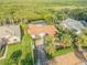 House with driveway, lush landscaping, and canal access at 40 Oak Tree Dr, New Smyrna Beach, FL 32169