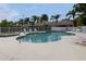 Community pool with lounge chairs and spa at 2290 Hawks Cove Cir, New Smyrna Beach, FL 32168