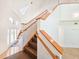 View of the wooden staircase from the living room at 624 Volco Rd, Edgewater, FL 32141