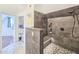 Walk-in shower with gray tile, built-in seat, and updated fixtures at 624 Volco Rd, Edgewater, FL 32141