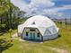 Unique dome-shaped home with a spacious lawn and lush landscaping at 624 Volco Rd, Edgewater, FL 32141