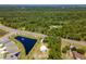 Aerial view showing dome house, pond, and surrounding nature at 624 Volco Rd, Edgewater, FL 32141