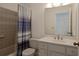 Bathroom with shower/tub combo and white vanity at 1319 Orange Tree Dr, Edgewater, FL 32132